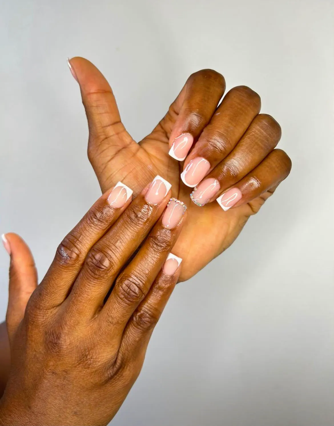 Valdine applying premium nail polish during a private nail service